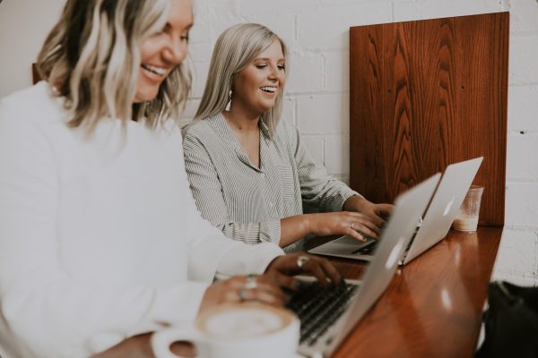 Two people working at their laptops
