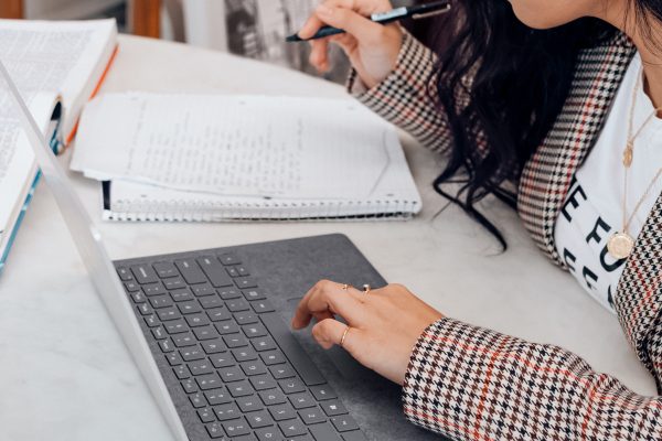 A person writing notes